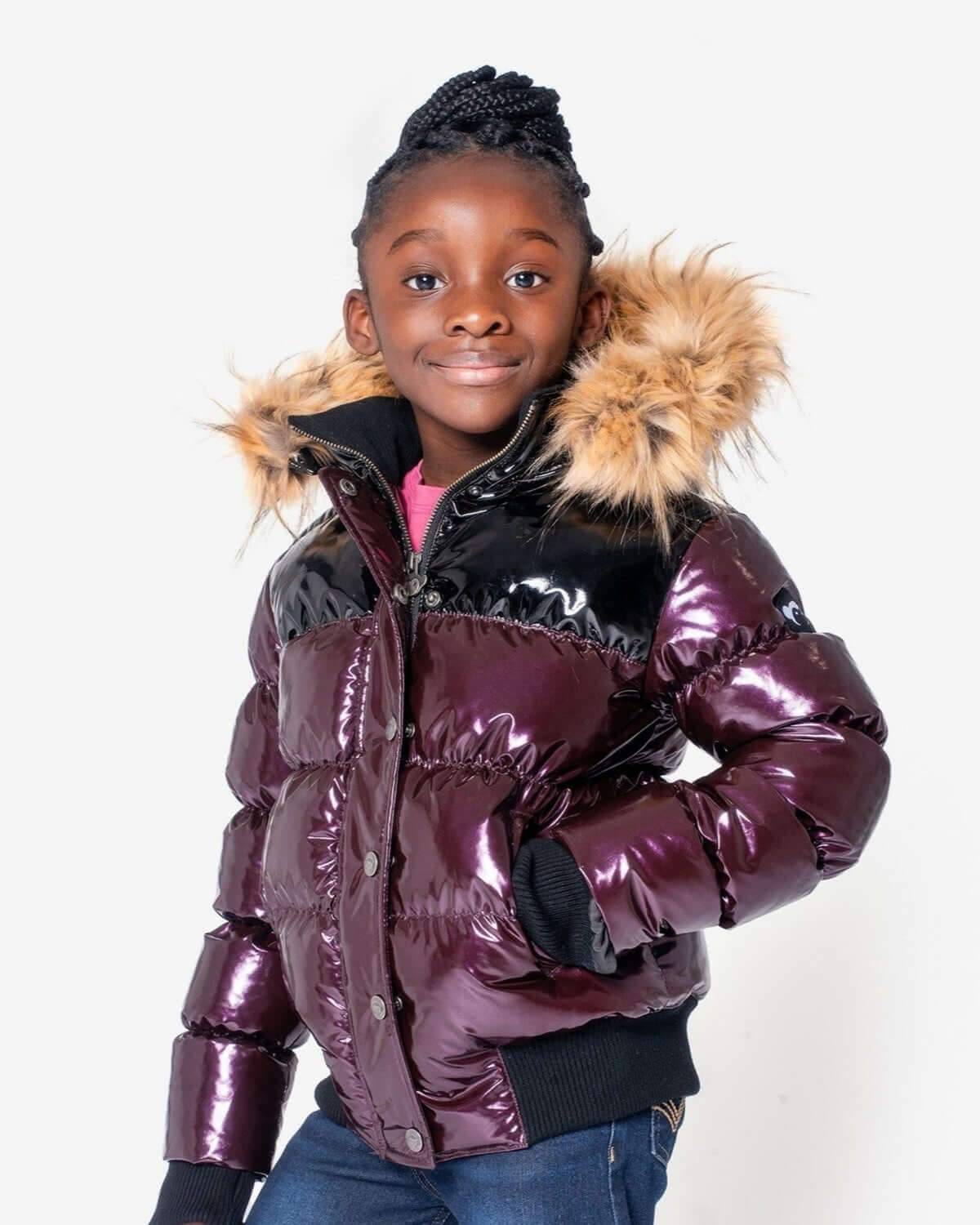 Stylish girl in a burgundy/black Kyla Puffer Coat with faux fur hood—perfect for winter fun in high-quality kids clothes!