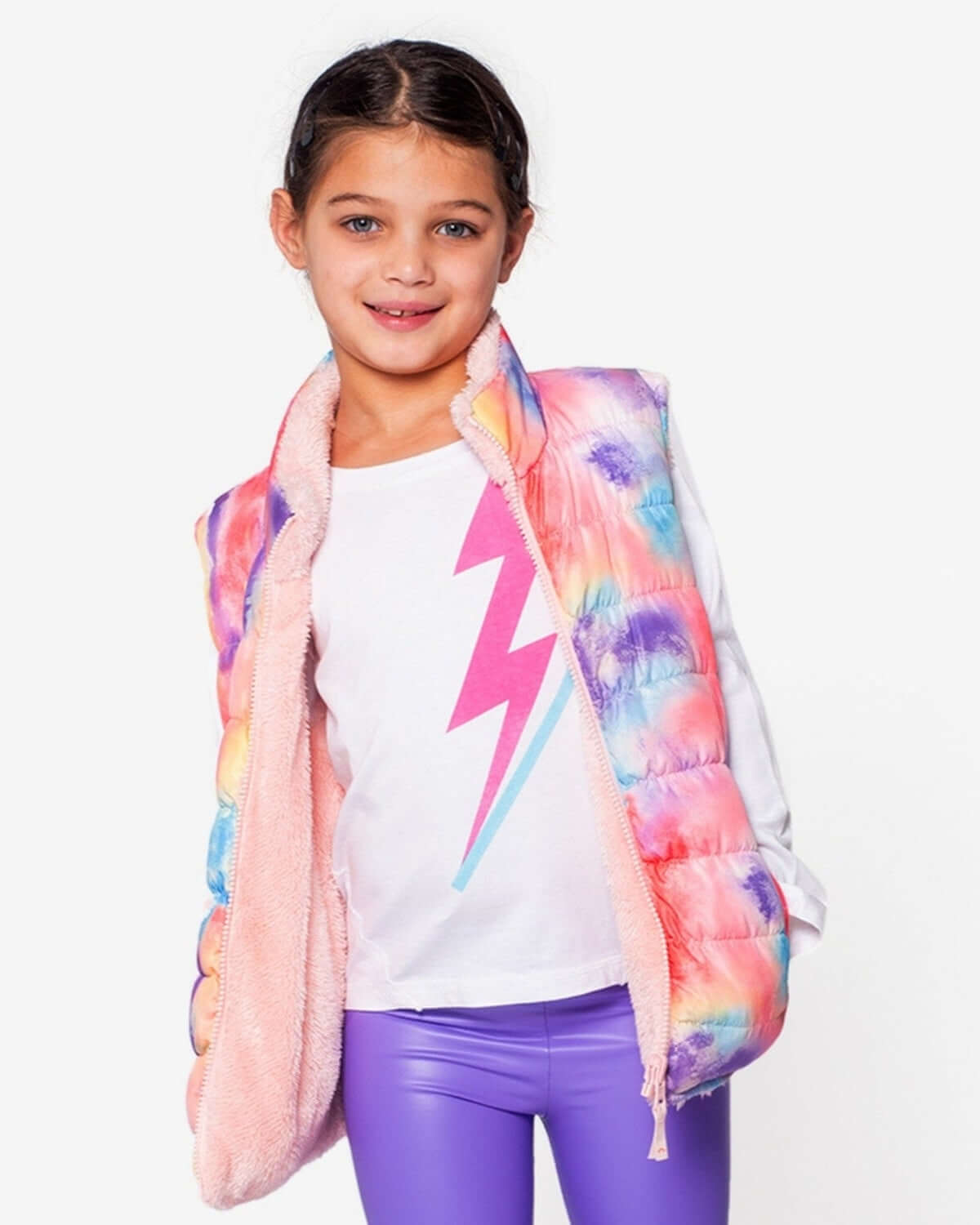 Girl rocking the Candy Cloud Reversible Vest, flaunting colors and cozy faux fur for stylish winter adventures.