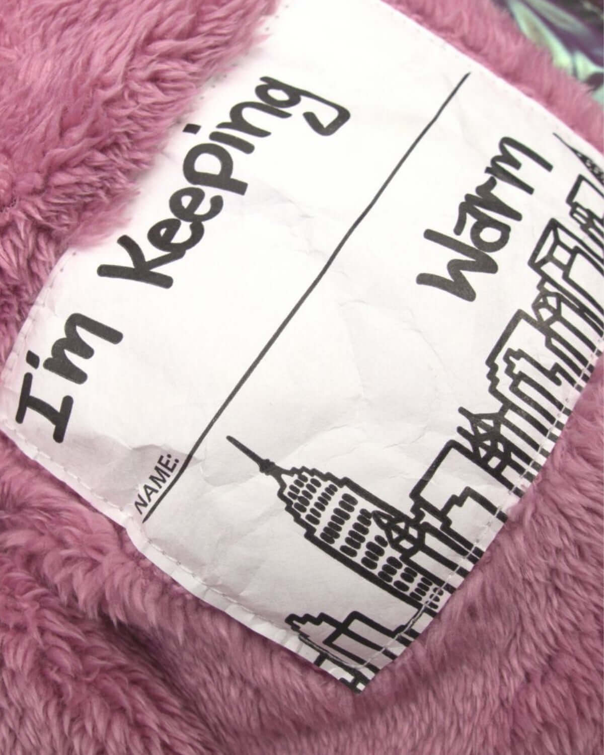 Cozy Code Pink puffer coat label with playful design saying 'I'm Keeping Warm'—a stylish kids winter essential!