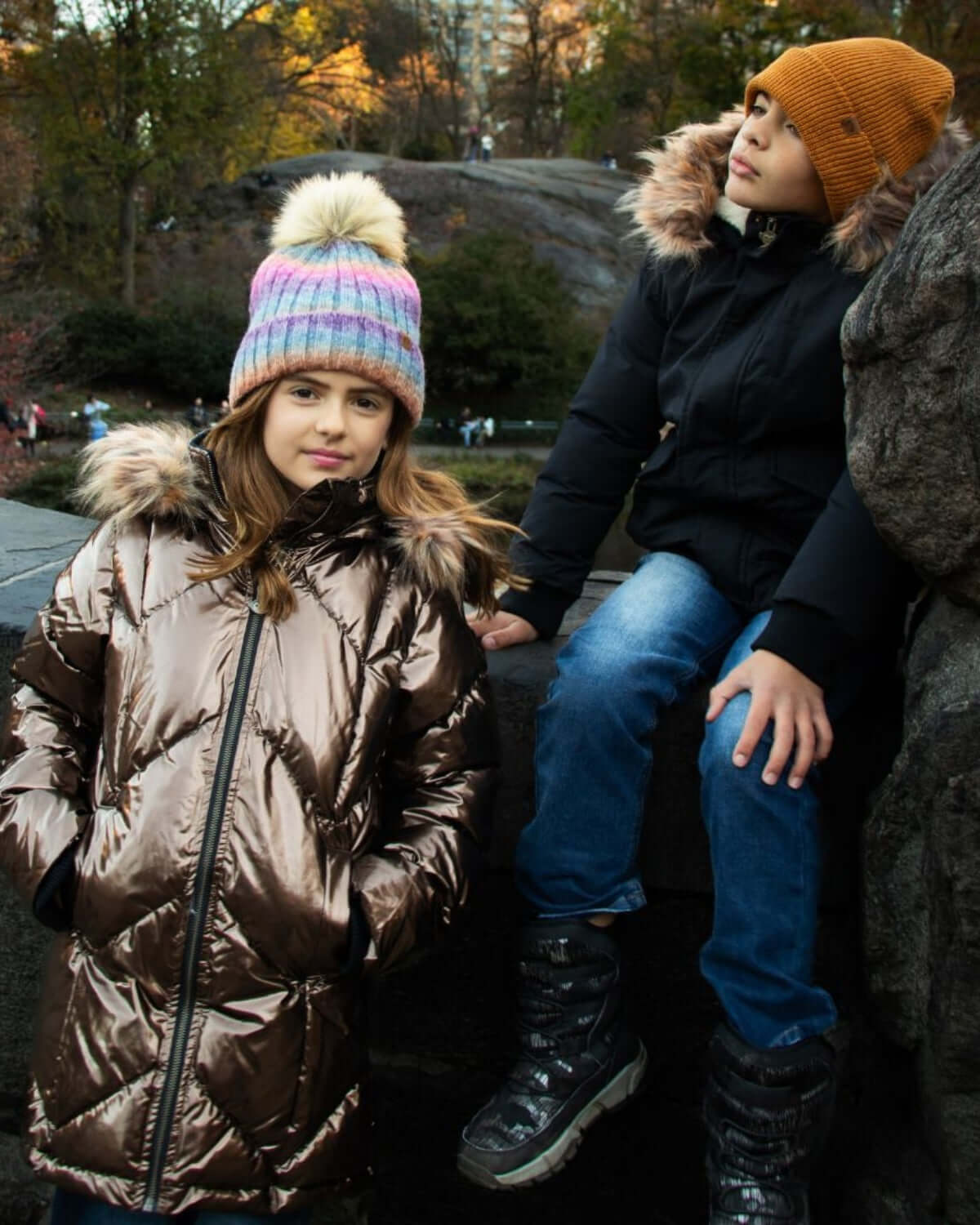 Kids stylish in cozy winter coats, embracing playtime in the park—perfect for back to school adventures!