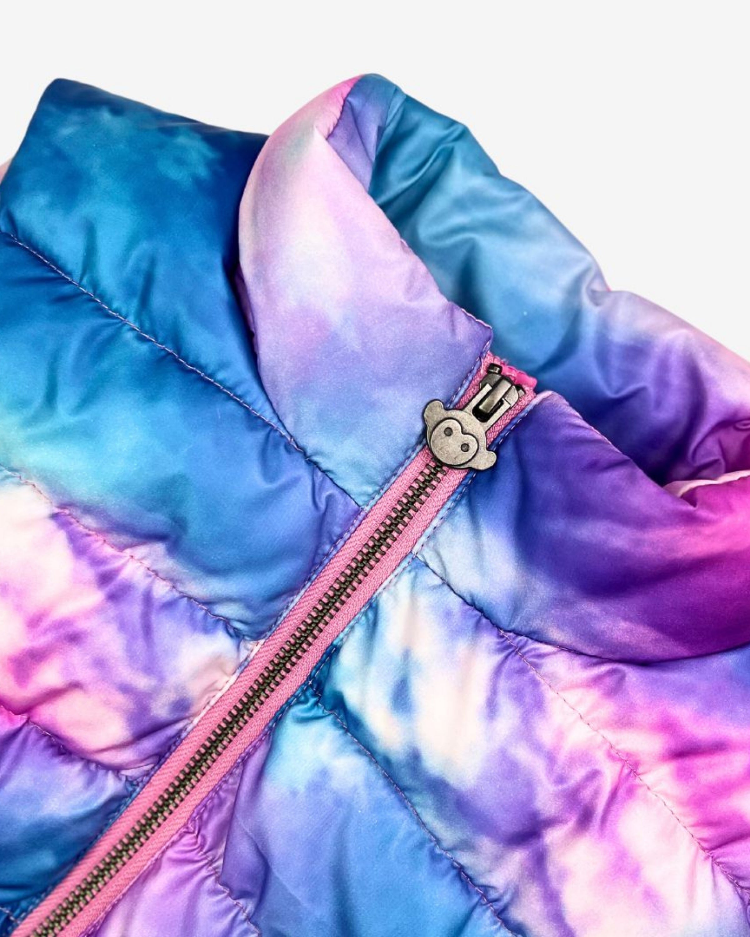 Dream Cloud Puffer Vest detail with vibrant blue, white, and pink hues, showcasing stylish design for trendy kids.