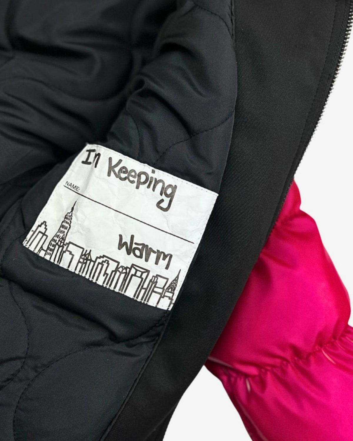 Inside pocket tag of the Fuchsia Flurry Coat, reminding kids to stay warm in style. Perfect for back to school adventures!