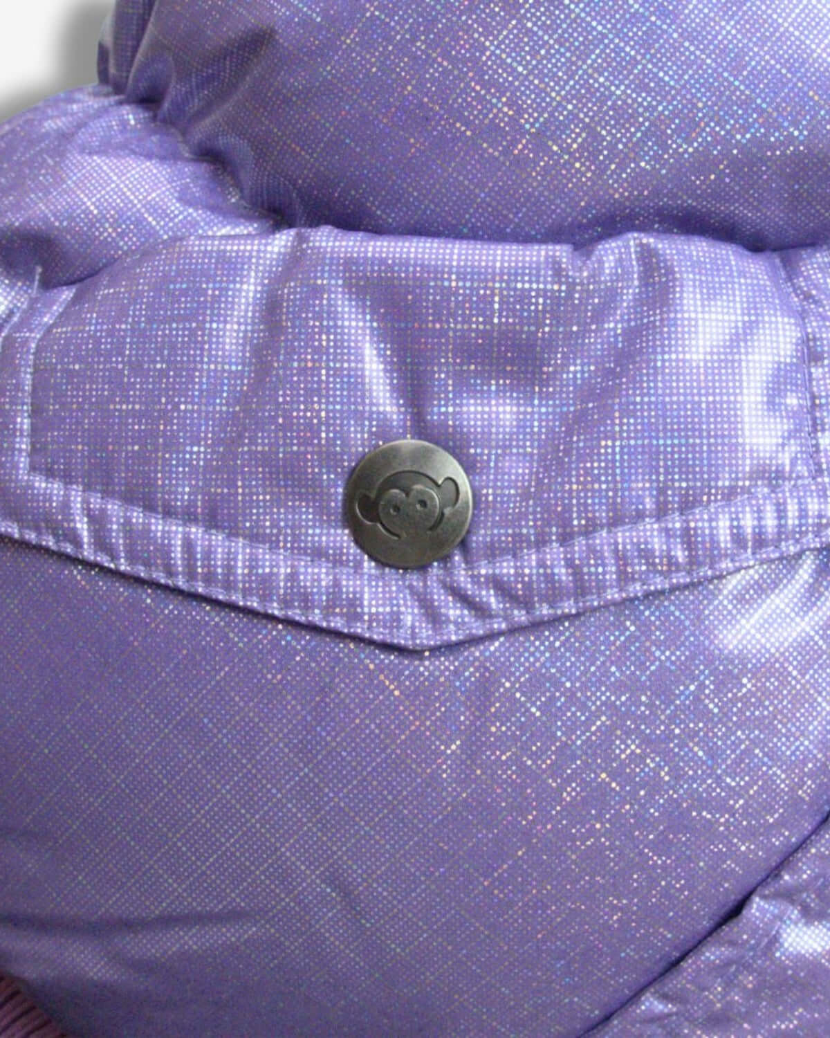 Close-up of the Glacial Purple Puffy Coat button, showcasing the stylish design for kids' winter wear.
