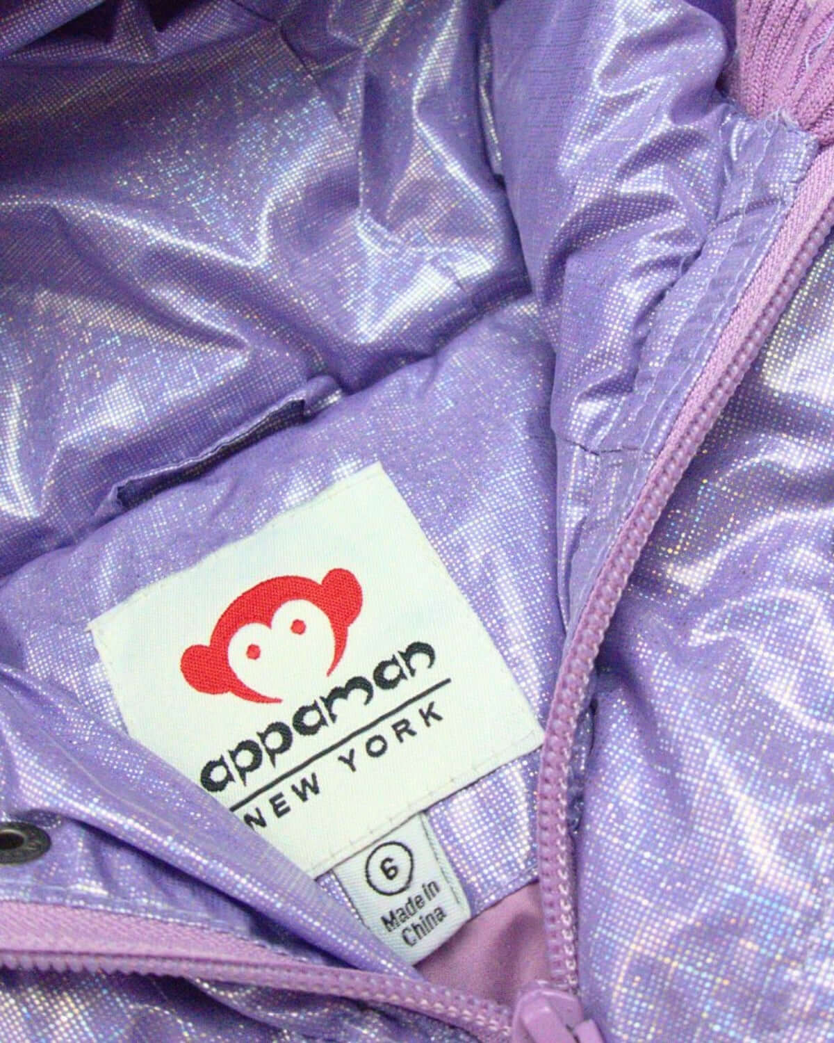 Inside view of the Glacial Purple Puffy Coat, showcasing Appaman's fun logo and stylish lining—ideal for kids' winter adventures!