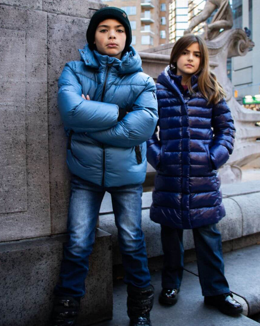 Stylish kids rocking the Blue Lovi Long Puffer coats in the city—kids clothes that blend warmth and flair for back to school!