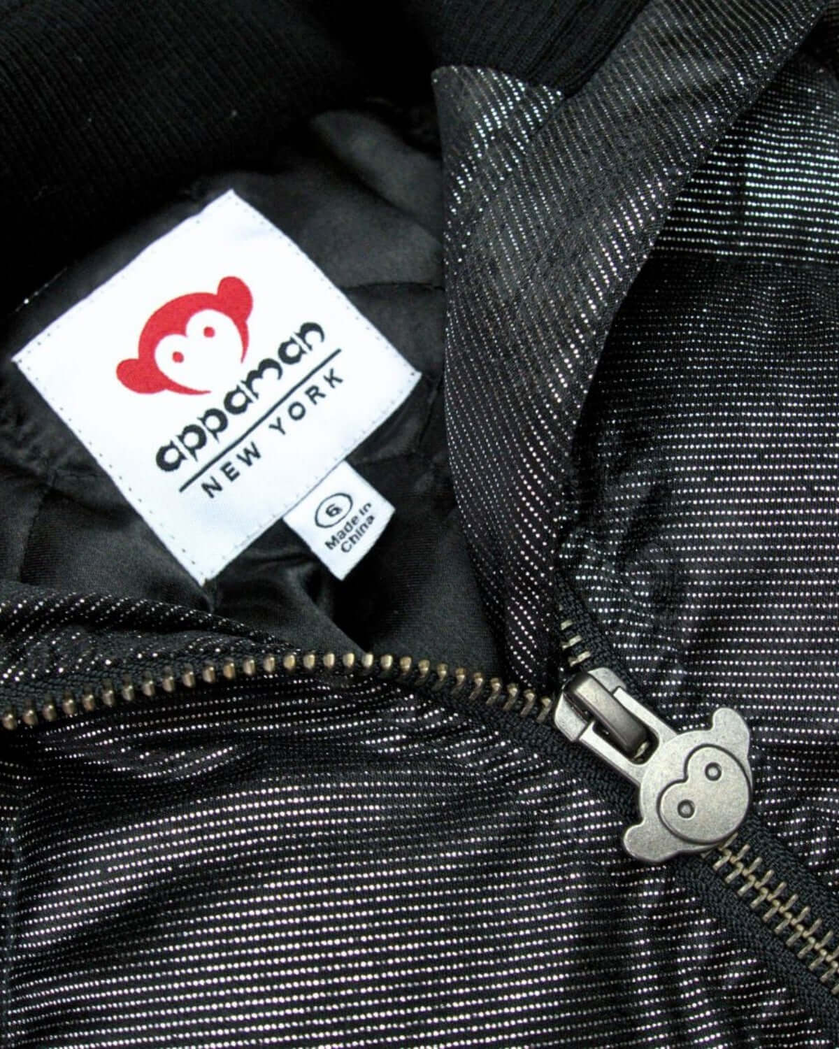 Close-up of Appaman's signature logo and playful zipper pull on a stylish jacket, perfect for trendy kids.