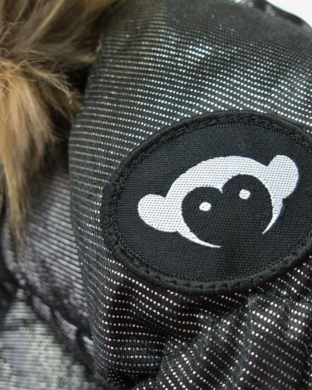 A close-up of the playful Appaman logo on the cozy Nova Long Coat, ready to add fun warmth to winter adventures!