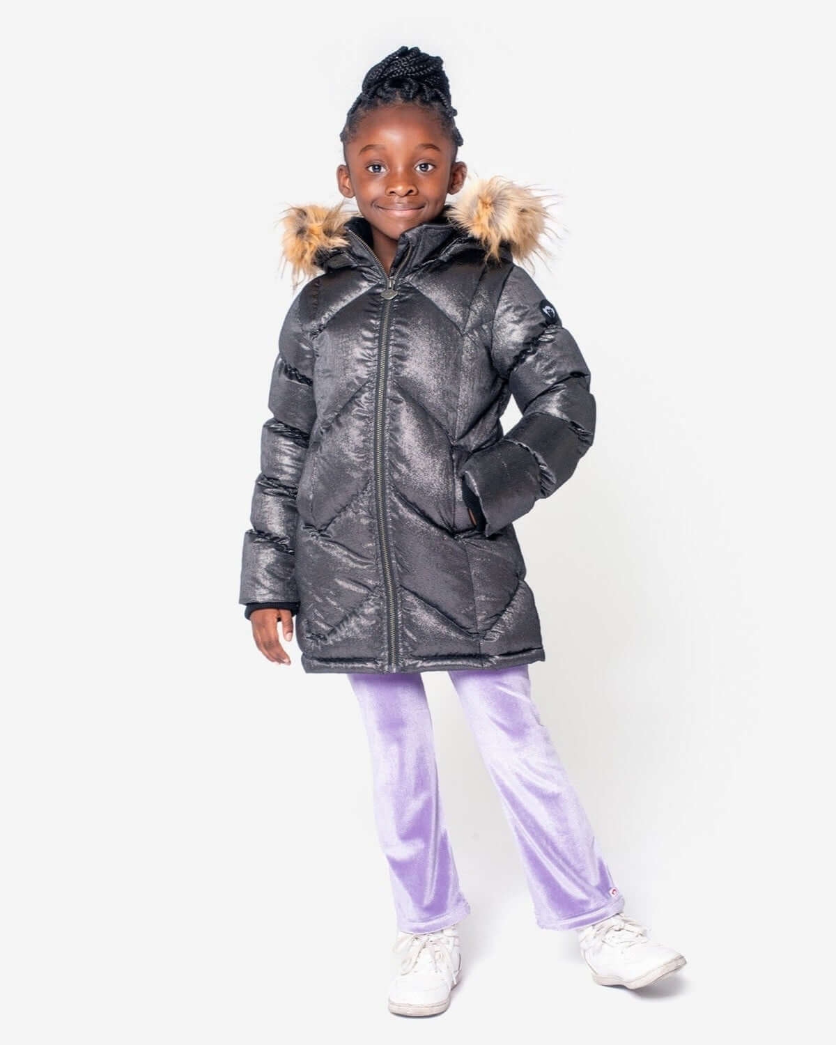 Stylish girl in a black Nova Long Coat with faux fur hood, ready for winter adventures in cozy, fun kids clothes.