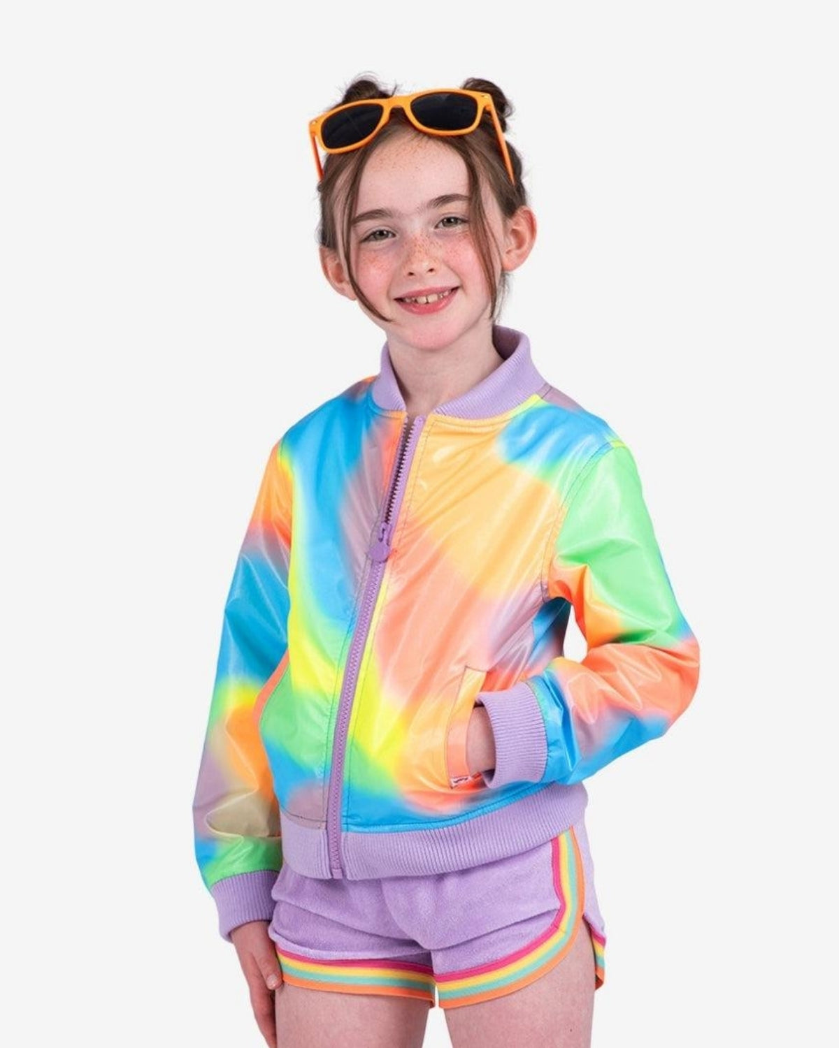 Stylish girl in a rainbow bomber jacket with purple trim and sunglasses, rocking kids clothes for back to school.