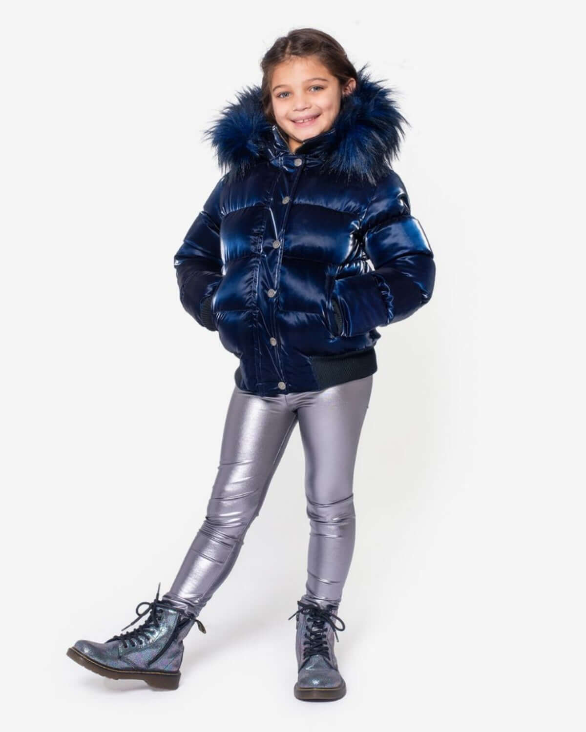 Stylish girl rocking the Navy Shine Kyla Puffer Coat, glammed up for winter fun in shiny silver leggings!