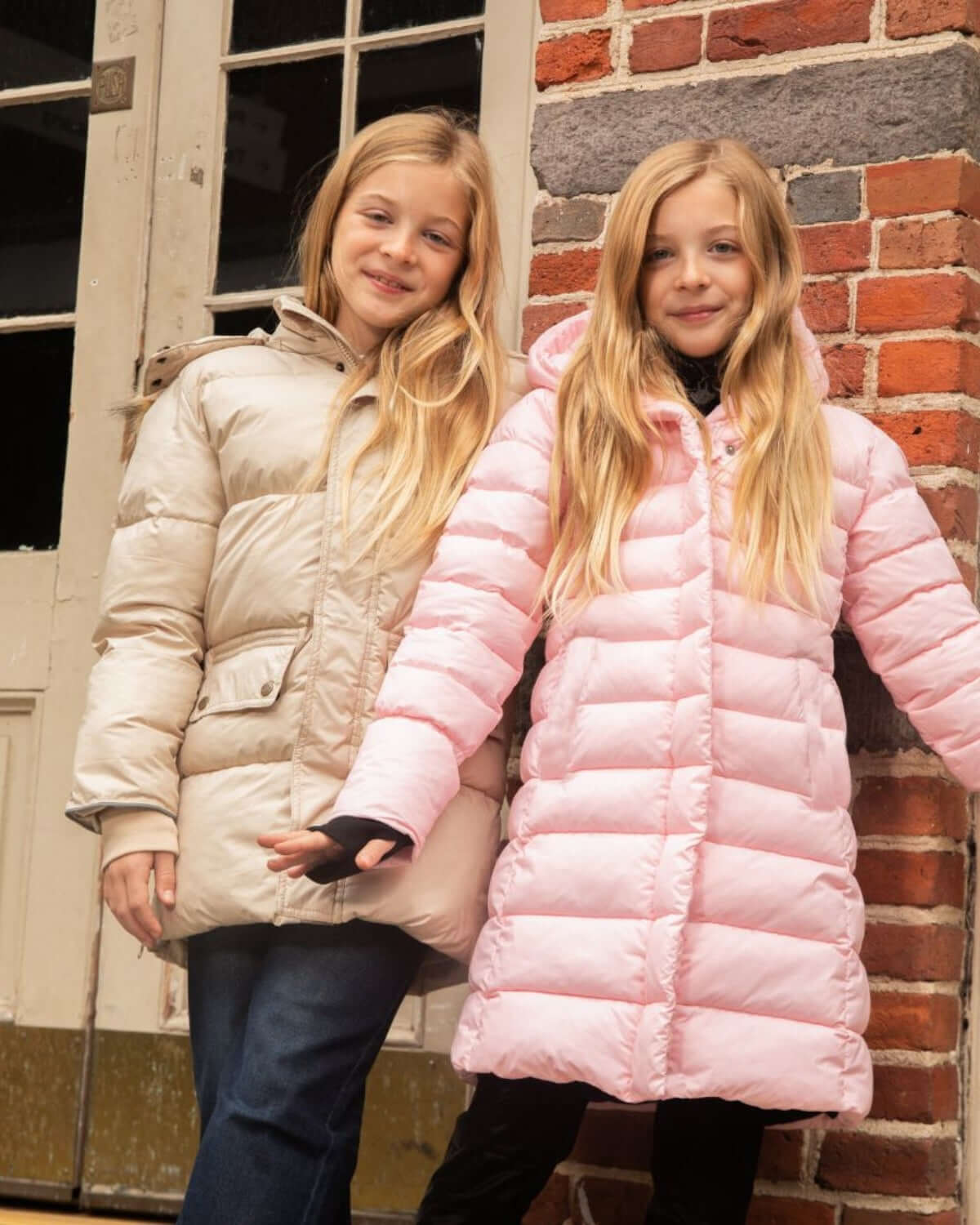 Two stylish girls in cozy puffer coats, ready for chilly days. Chic kids clothes that keep them warm and playful! #BackToSchool