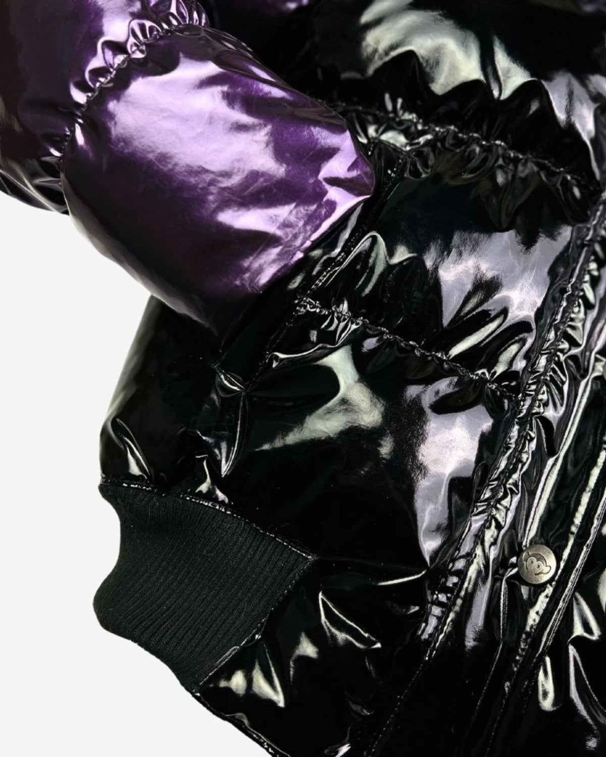 Shiny Plum and Black Kyla Puffer Coat sleeve, a stylish blend of warmth and fun for trendy winter adventures.