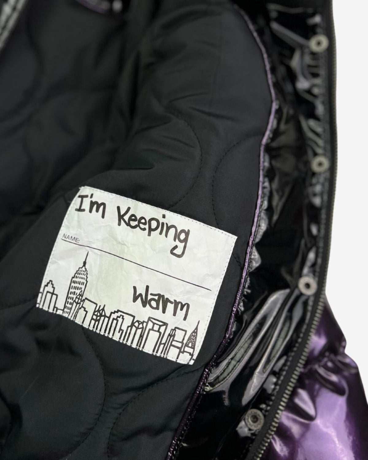 Cozy and playful inner label of the Kyla Puffer Coat, reminding kids they're stylishly warm this winter!