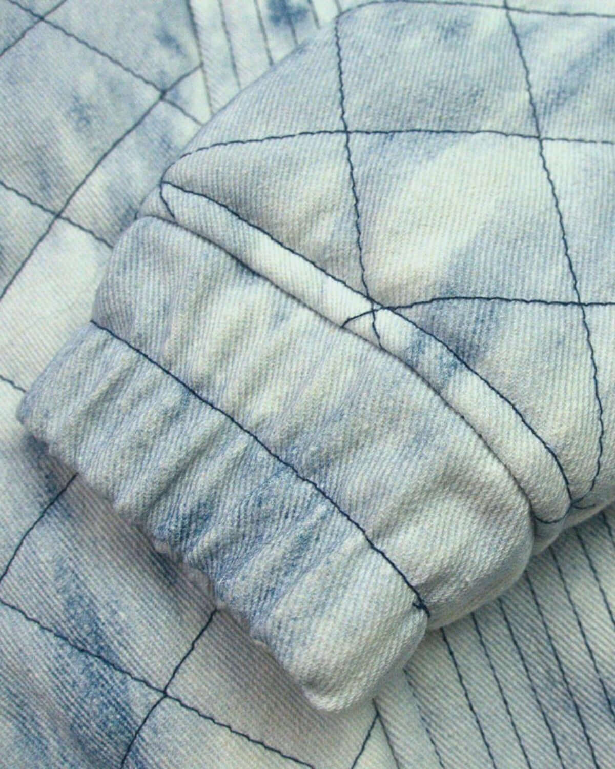 Close-up of Appaman's washed denim Hazel Jean Jacket showcasing diamond-quilted texture and stylish cuff detail.