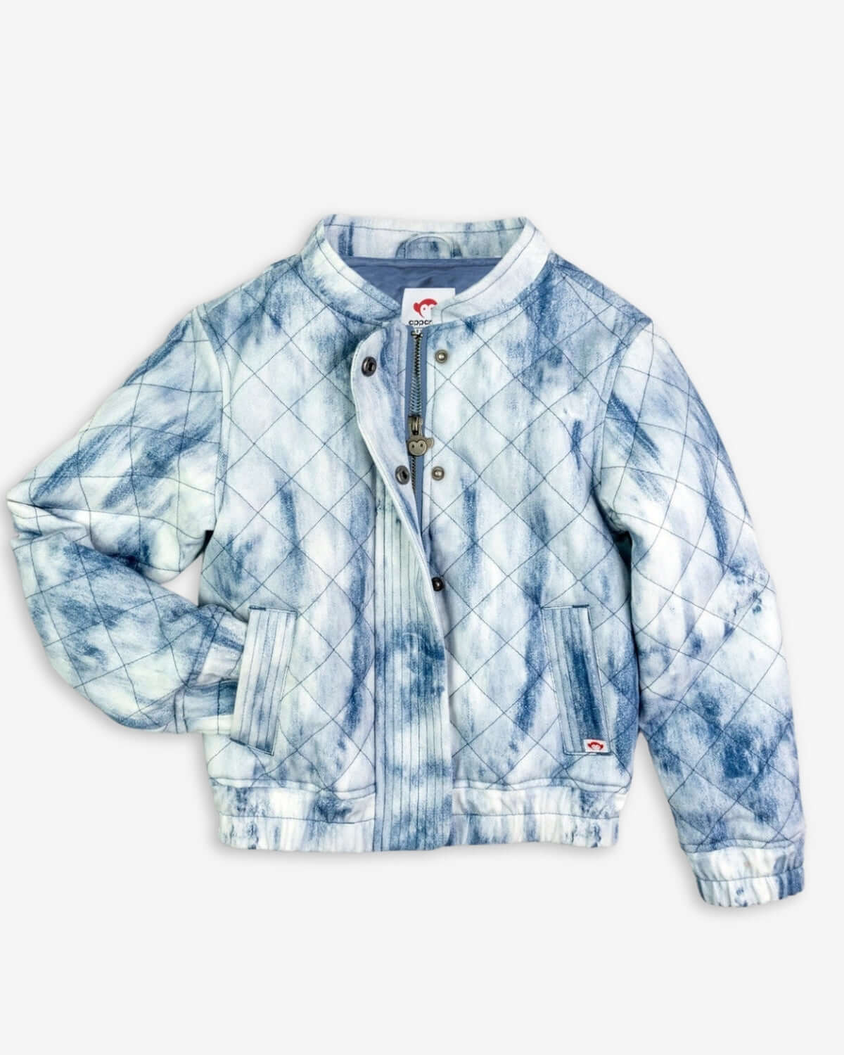 Stylishly quilted kids jacket in washed denim, boasting a playful tie-dye design—perfect for back-to-school chic!