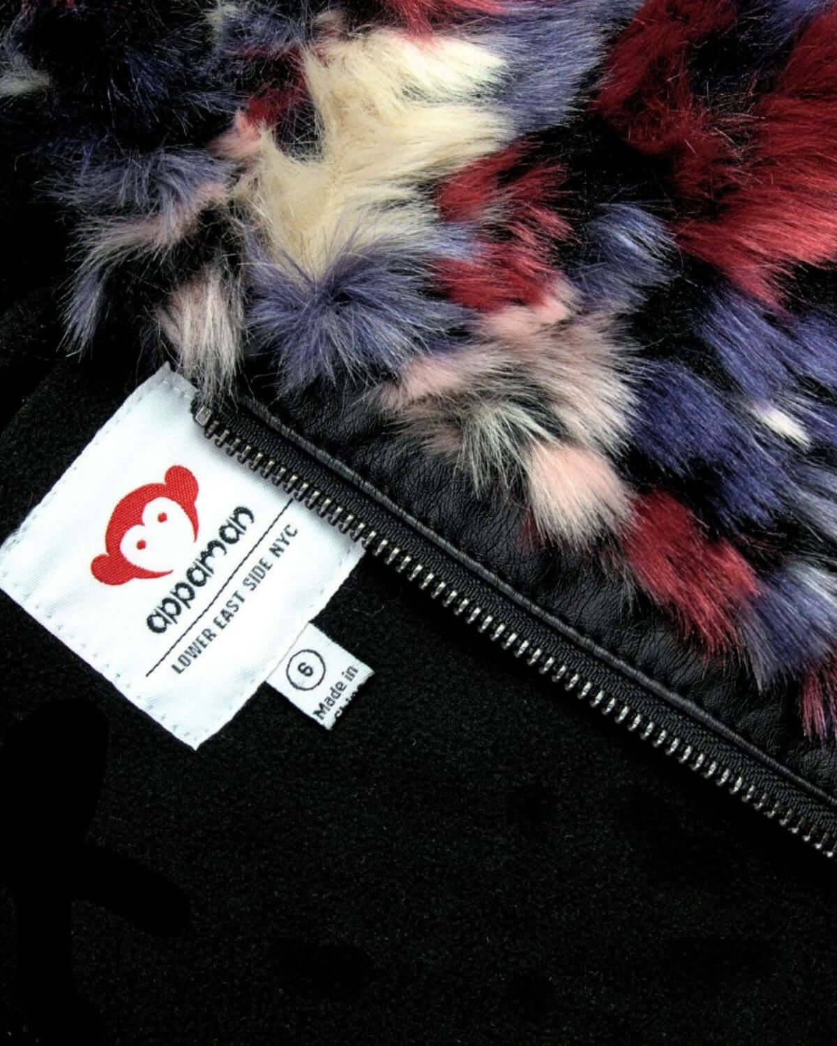 Cozy detail of the Appaman Luna Hoodie Jacket, showcasing vibrant fuzzy fabric and playful monkey logo.