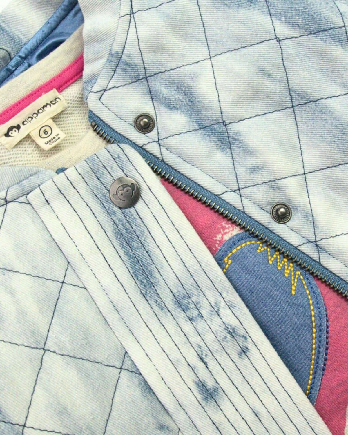 Close-up of Appaman's stylish denim quilted jacket, layered over vibrant kids clothes, showcasing comfort and playful style.