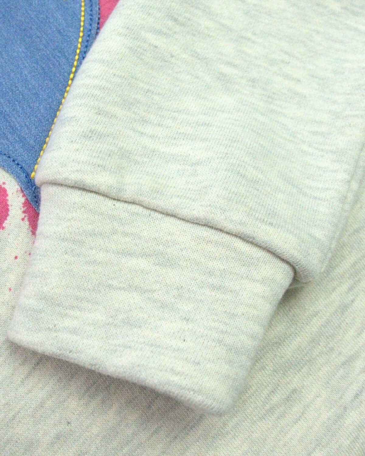 Close-up of the soft sleeve of the Applique Heart Ruby Sweatshirt, showcasing quality kids' fashion for school style.