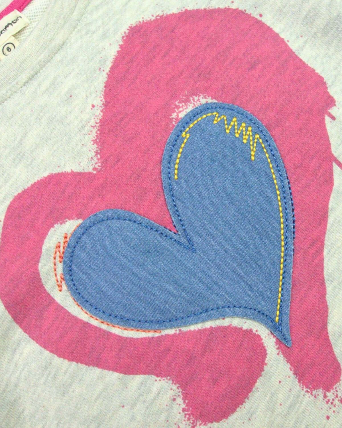 Stylish denim heart patch on a playful Ruby sweatshirt—ideal for trendy kids' outfits this back to school season!