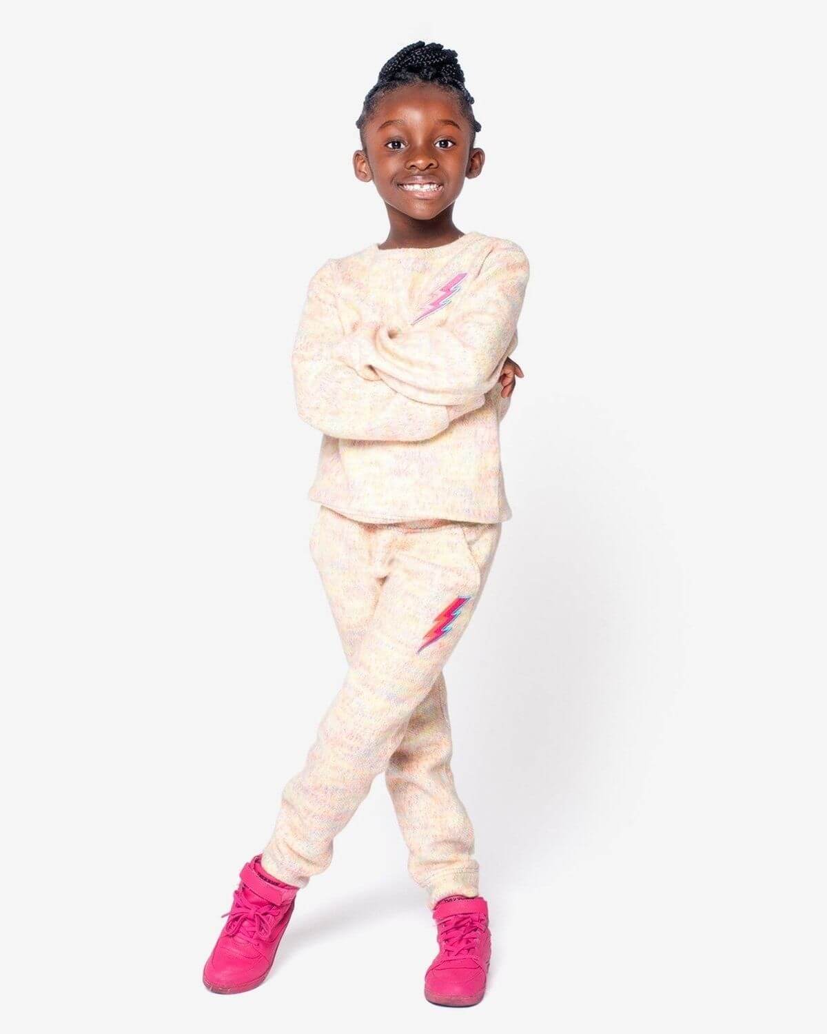 Stylish girl rocking Appaman's Lightning Bolt Ruby Sweatshirt and matching joggers, perfect for back to school fun in high-quality kids clothes.