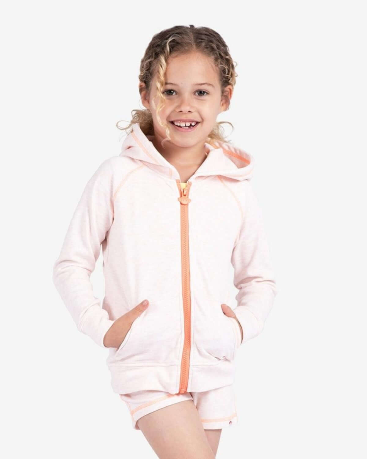 Joyful girl in a soft peach Julia hoodie, ready for fun adventures in high-quality kids clothes for back to school.