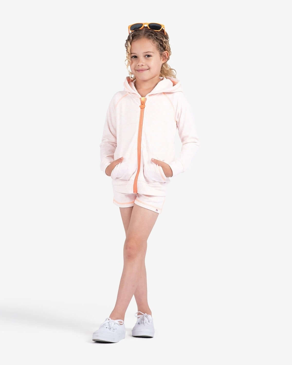 Stylish girl rocking the Peach Julia Hoodie, paired with matching shorts—perfect for sporty adventures and back to school fun!