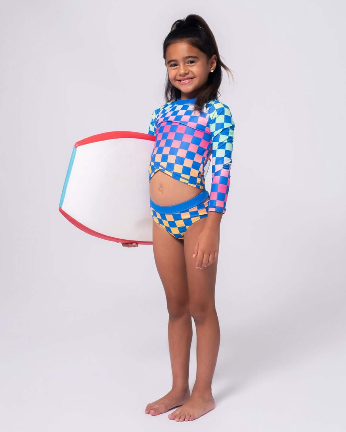 Vibrant checkerboard rash guard set for girls, perfect for beach fun and pool parties, combining style and UPF protection.