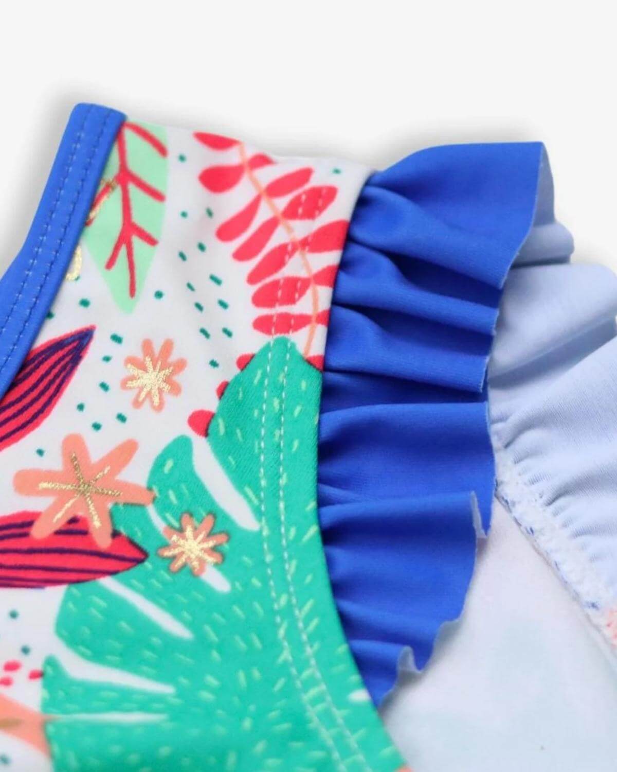 Close-up of the vibrant Floral Garden Hermosa Bikini Set featuring ruffle details and a fun tropical pattern.