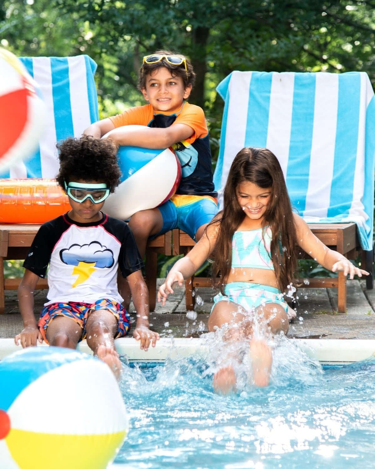 Three kids enjoying summer fun by the pool in vibrant swimwear, ready for beach adventures and splashes!
