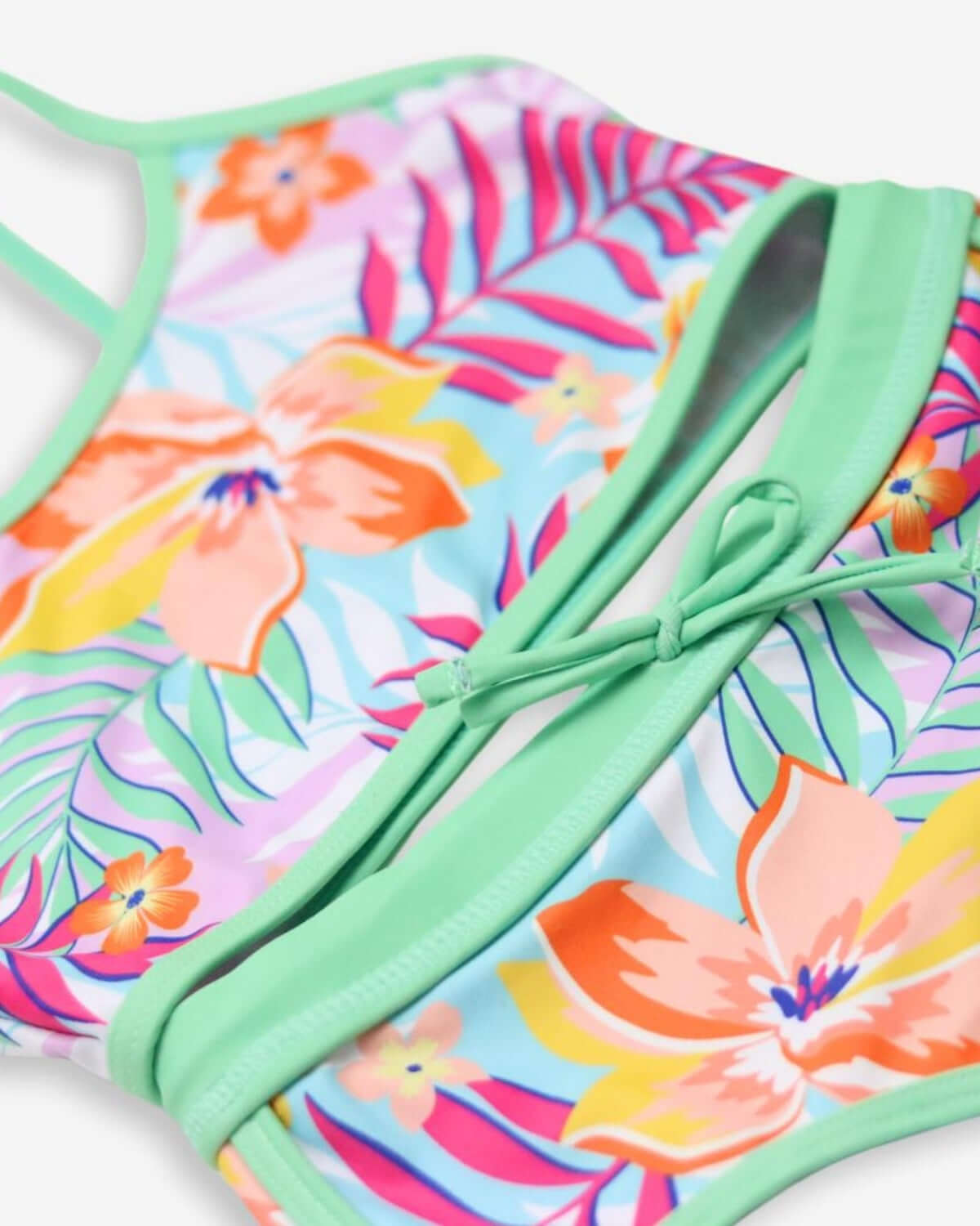 Colorful floral bikini detail with vibrant tropical design and soft green trim, ideal for sunny adventures!