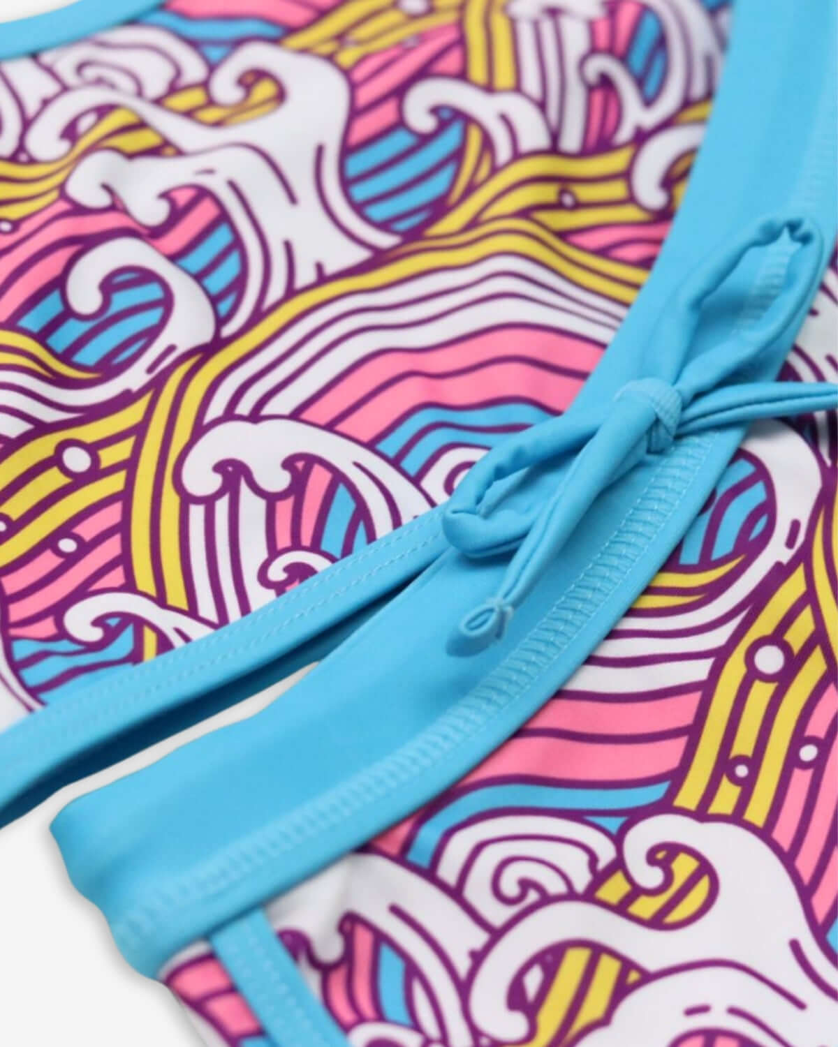 Close-up of the Waves Stella Bikini showcasing colorful wave patterns and a playful design perfect for summer adventures.