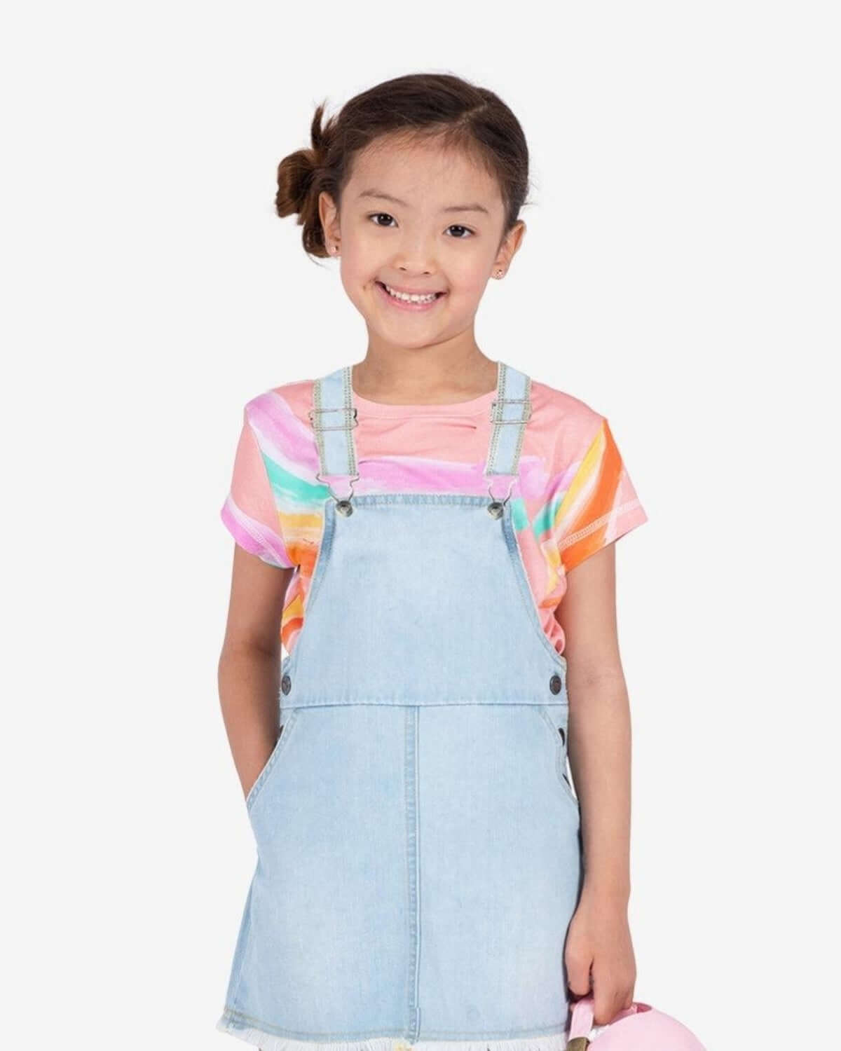 Bright and stylish girl in a colorful Brushstrokes Circle Tee paired with a denim overall—perfect kids clothes for fun adventures!