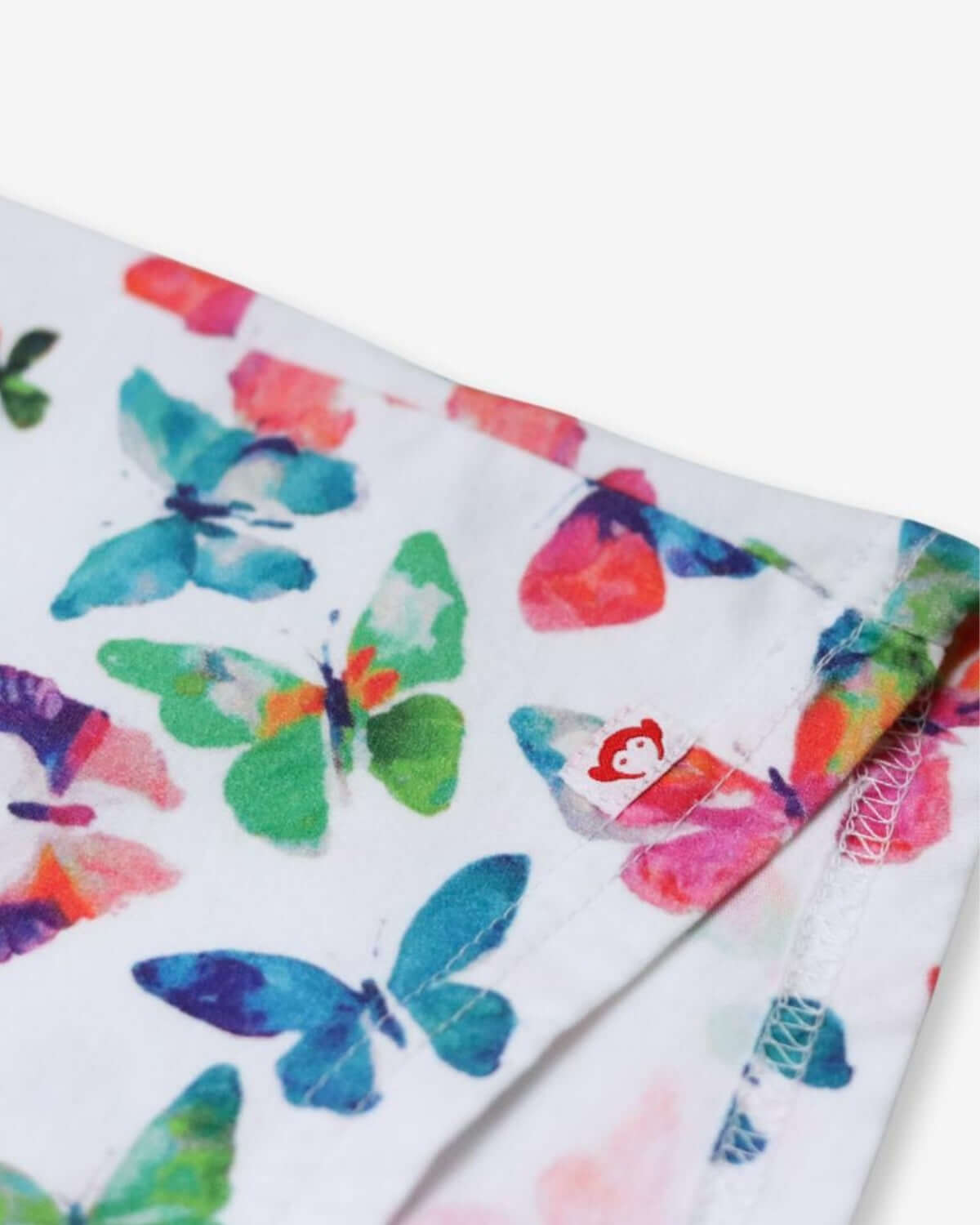 Close-up of the playful butterfly print on the Hazel Top—vibrant and stylish for kids' back-to-school adventures!