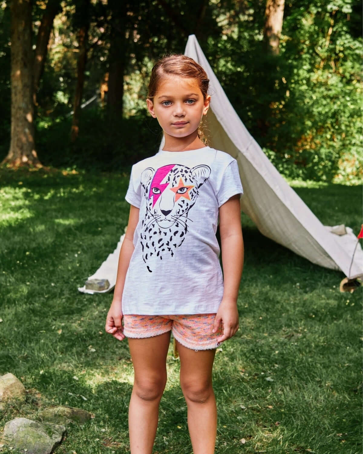 Stylish girl in the Cheetah Circle Tee, ready for adventures in high-quality kids clothes. Fun back-to-school look!