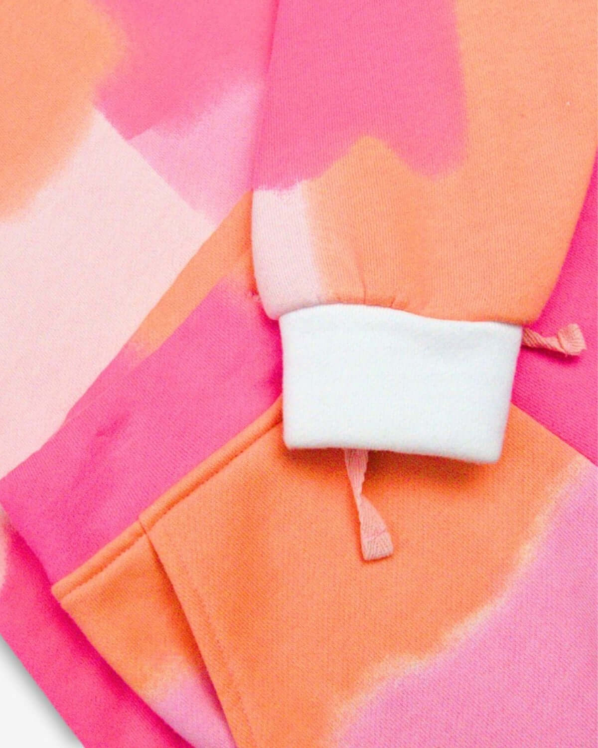 Cozy and playful color block detail of Appaman’s Sofia Top in vibrant orange and pink—perfect for stylish kiddos!