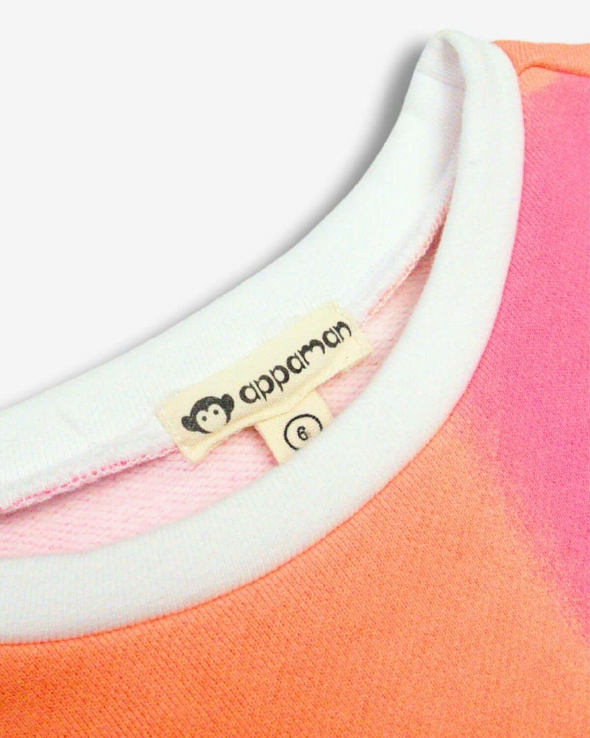 Close-up of Appaman's Kids Color Block Sofia Top, showcasing vibrant orange and pink fabric with soft sweatshirt lining.