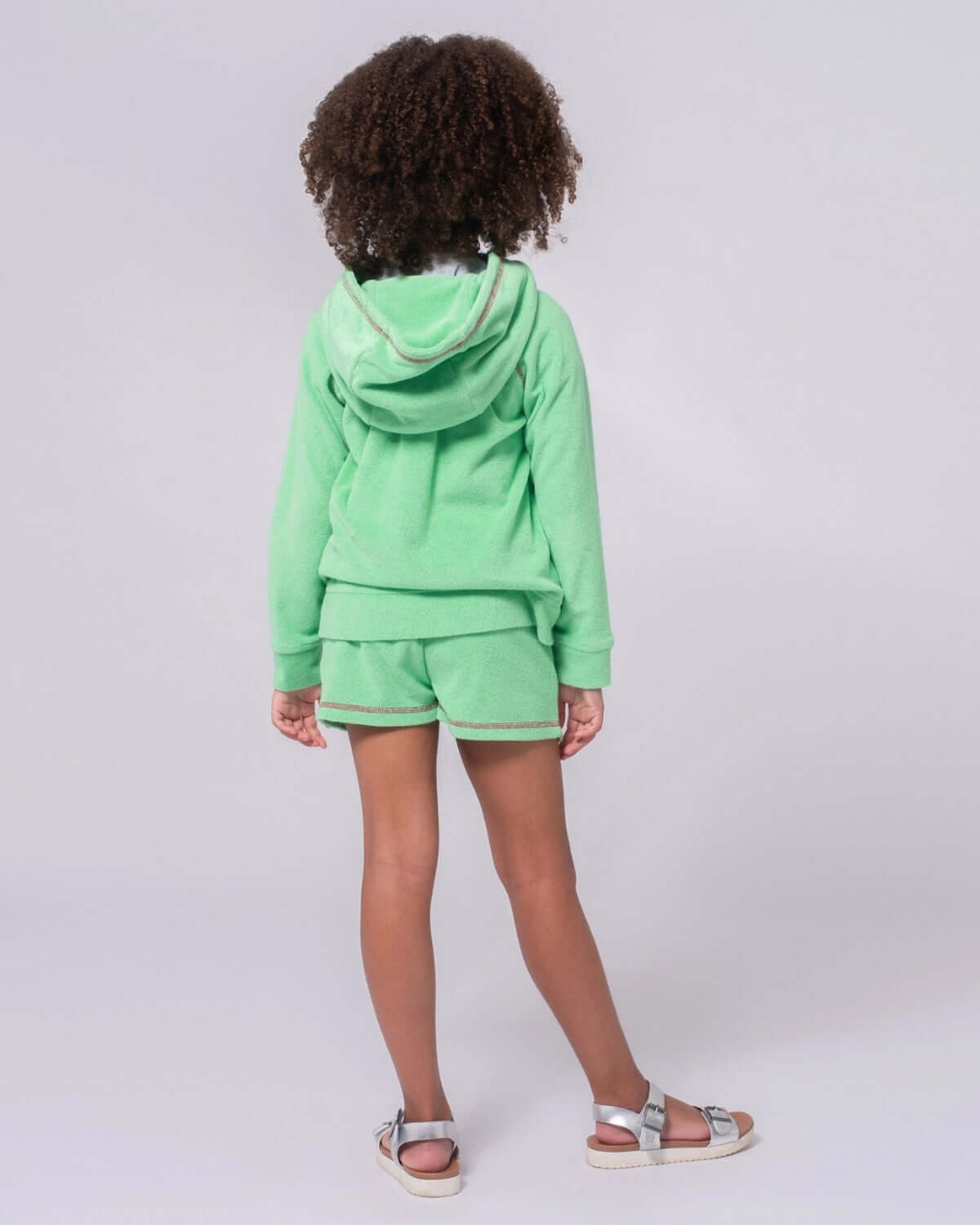 Cute kid in mint hoodie and shorts, blending style and comfort for playful adventures! Perfect kids clothes for back to school.