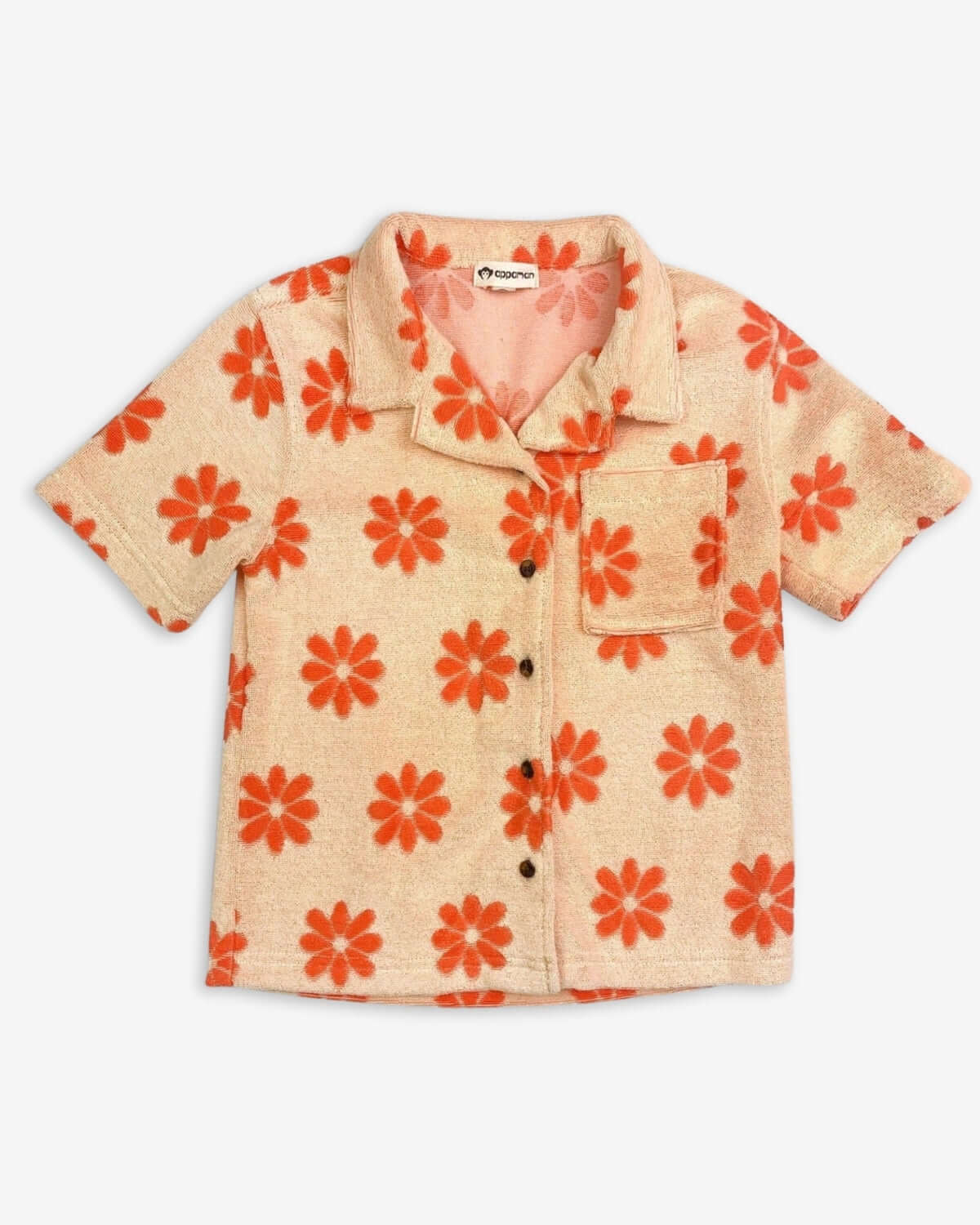 Light orange resort shirt for kids, featuring playful daisies. Stylish, comfy, and ready for sunny adventures!