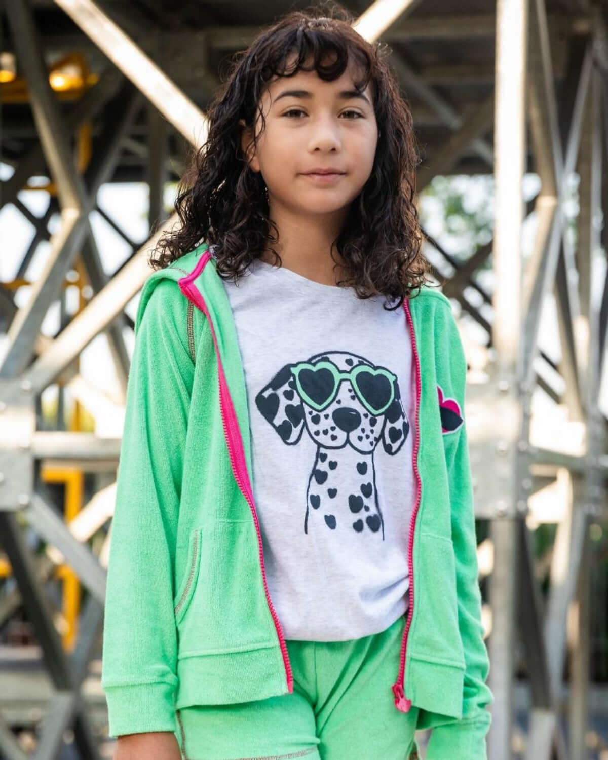 Cool girl rocking a playful Dalmatian tee with chic sunglasses, ready for school adventures in vibrant green!