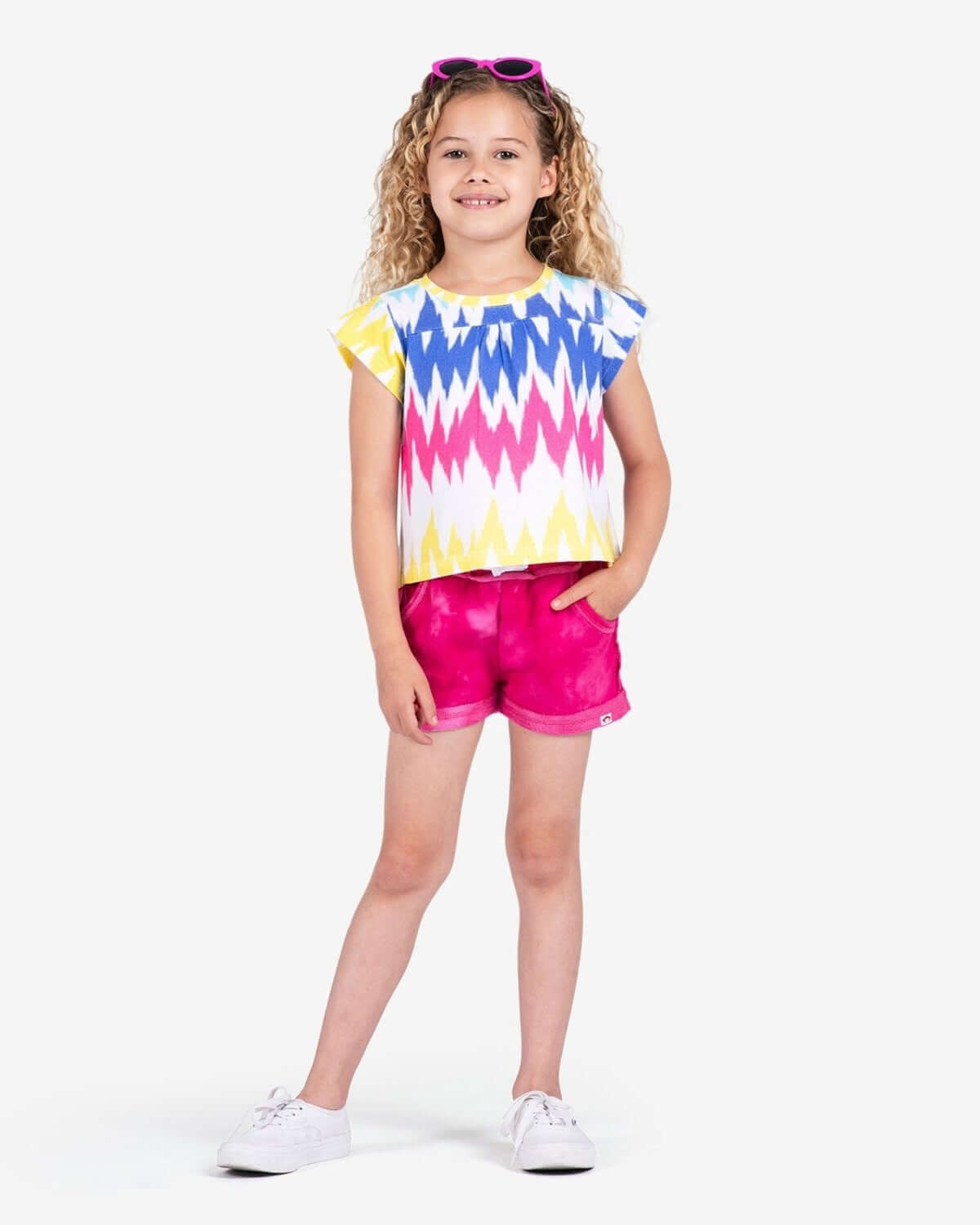 Bright and playful Multi Ikat Elsa Tee on a happy girl, showcasing vibrant colors for stylish kids' outfits this back to school.