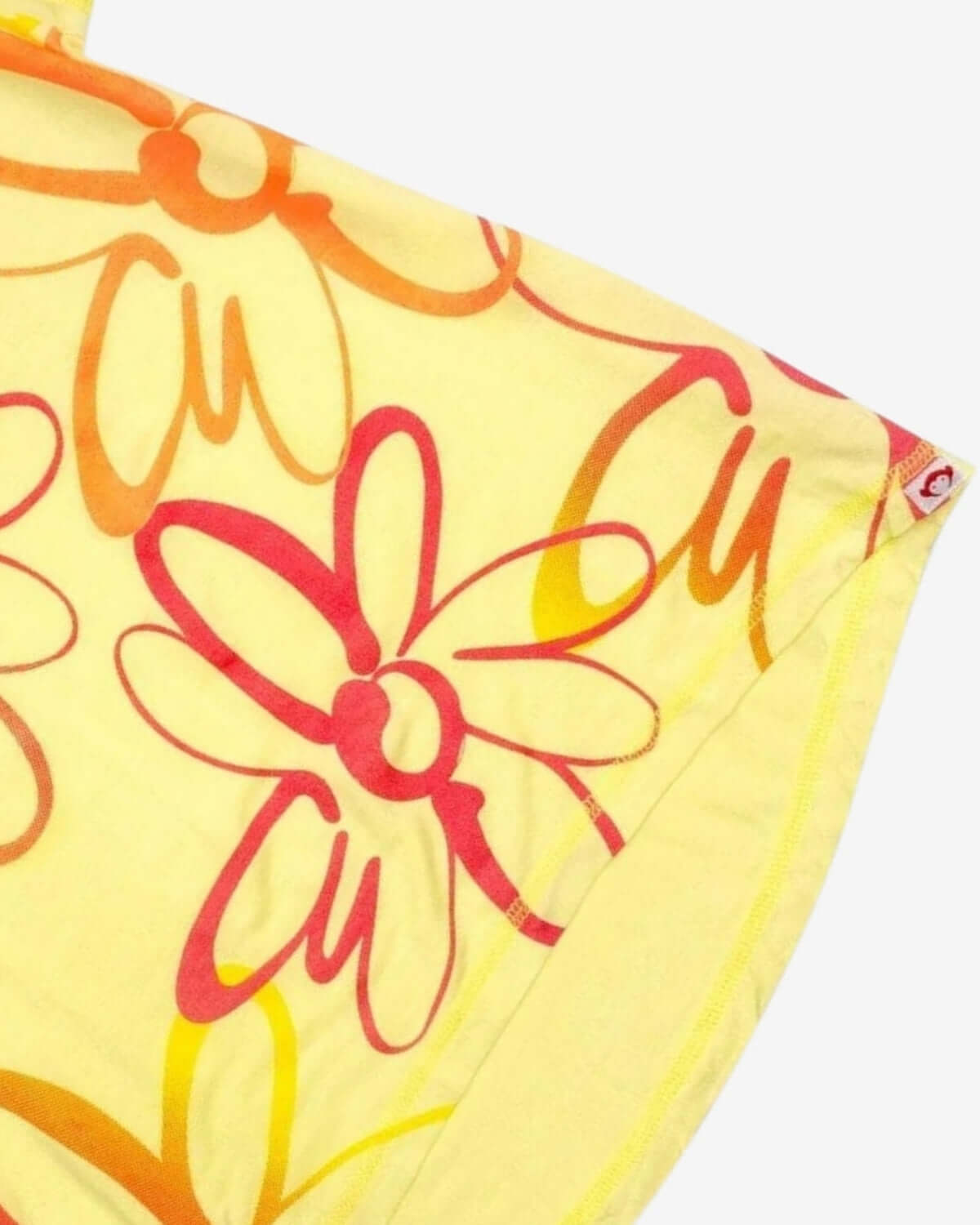 Bright yellow Circle Tee with whimsical multicolor daisy prints, adding a splash of fun to kids clothes for summer.