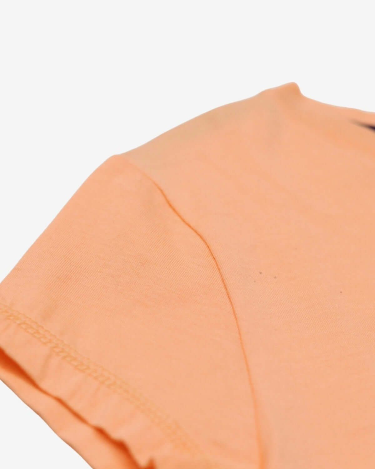 Soft peach fabric of the playful circle tee—ideal for stylish kids' adventures and back-to-school fun!