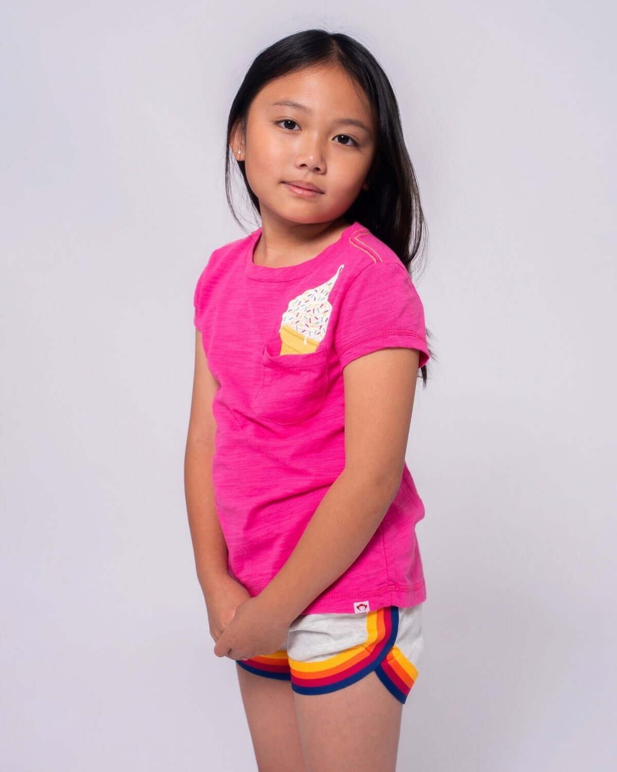 Girl wearing a vibrant Fuchsia Pocket Ice Cream Pocket Tee with ice cream design.