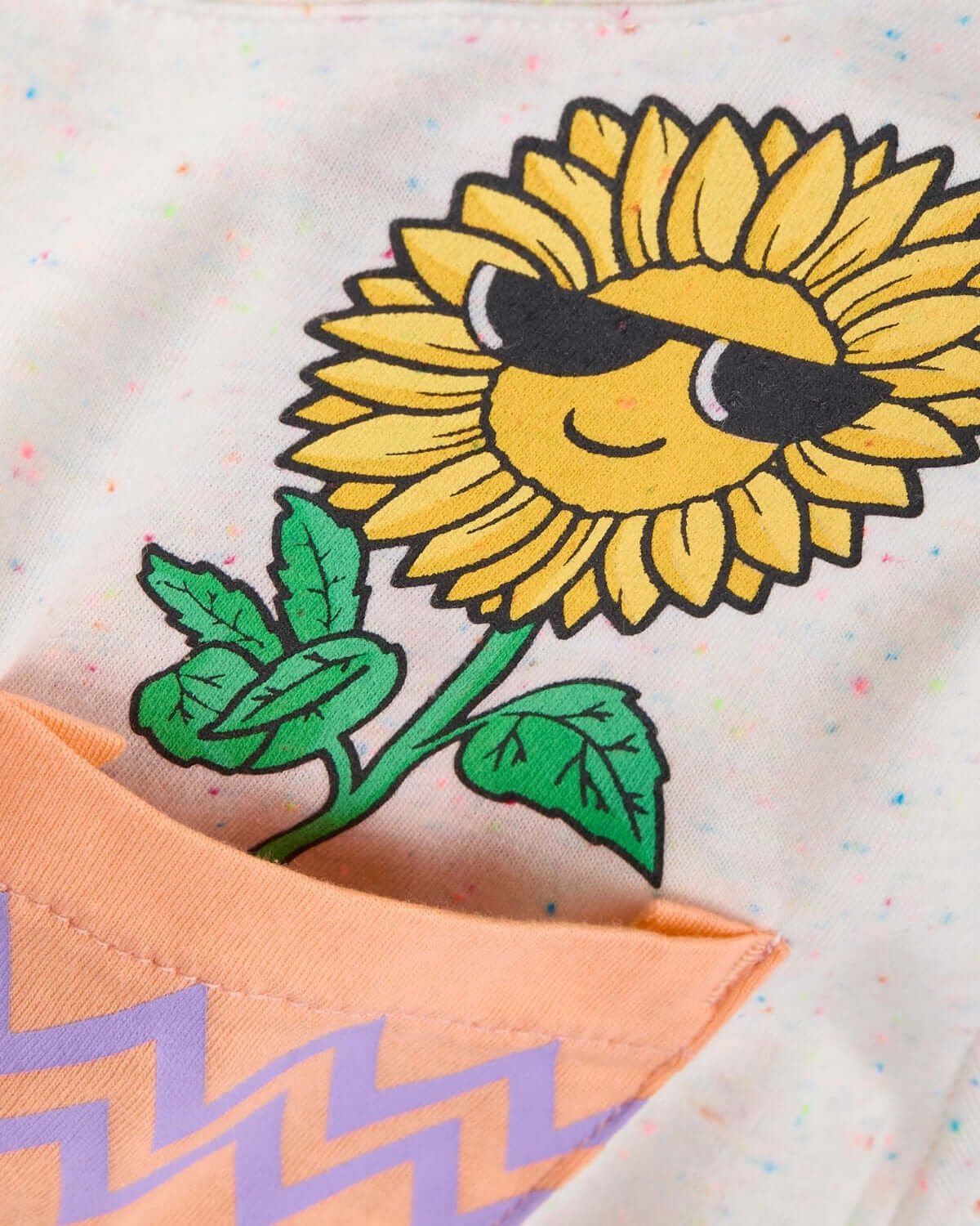 Cheery sunflower graphic on a speckled pocket tee for kids, adding fun style to girls clothes!