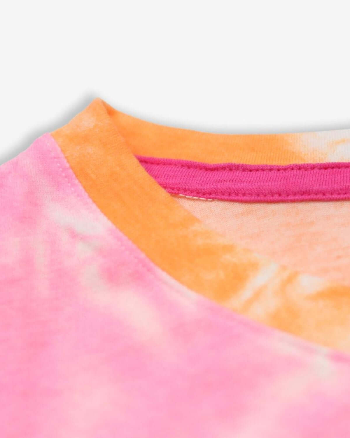 Close-up of vibrant pink and orange tie-dye collar on a soft kids' tee, showcasing colorful, stylish design.
