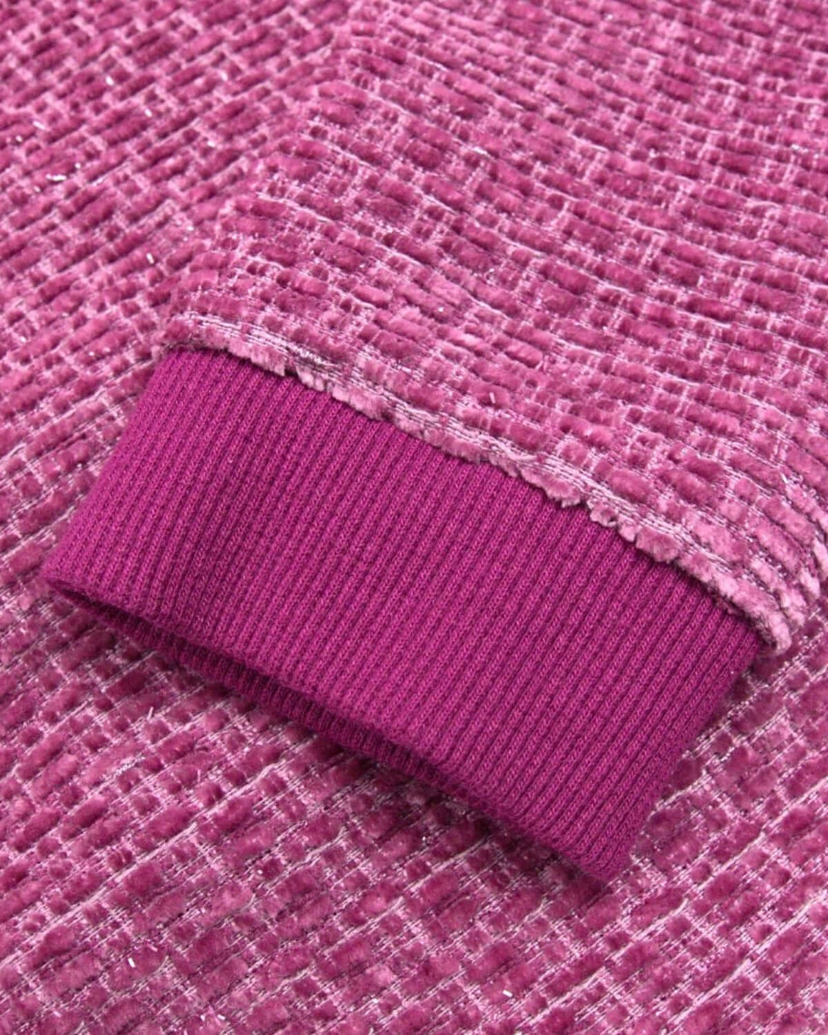 Detail of the Vintage Berry Laurel Top's stylish berry cuff, highlighting its playful texture and vibrant color.