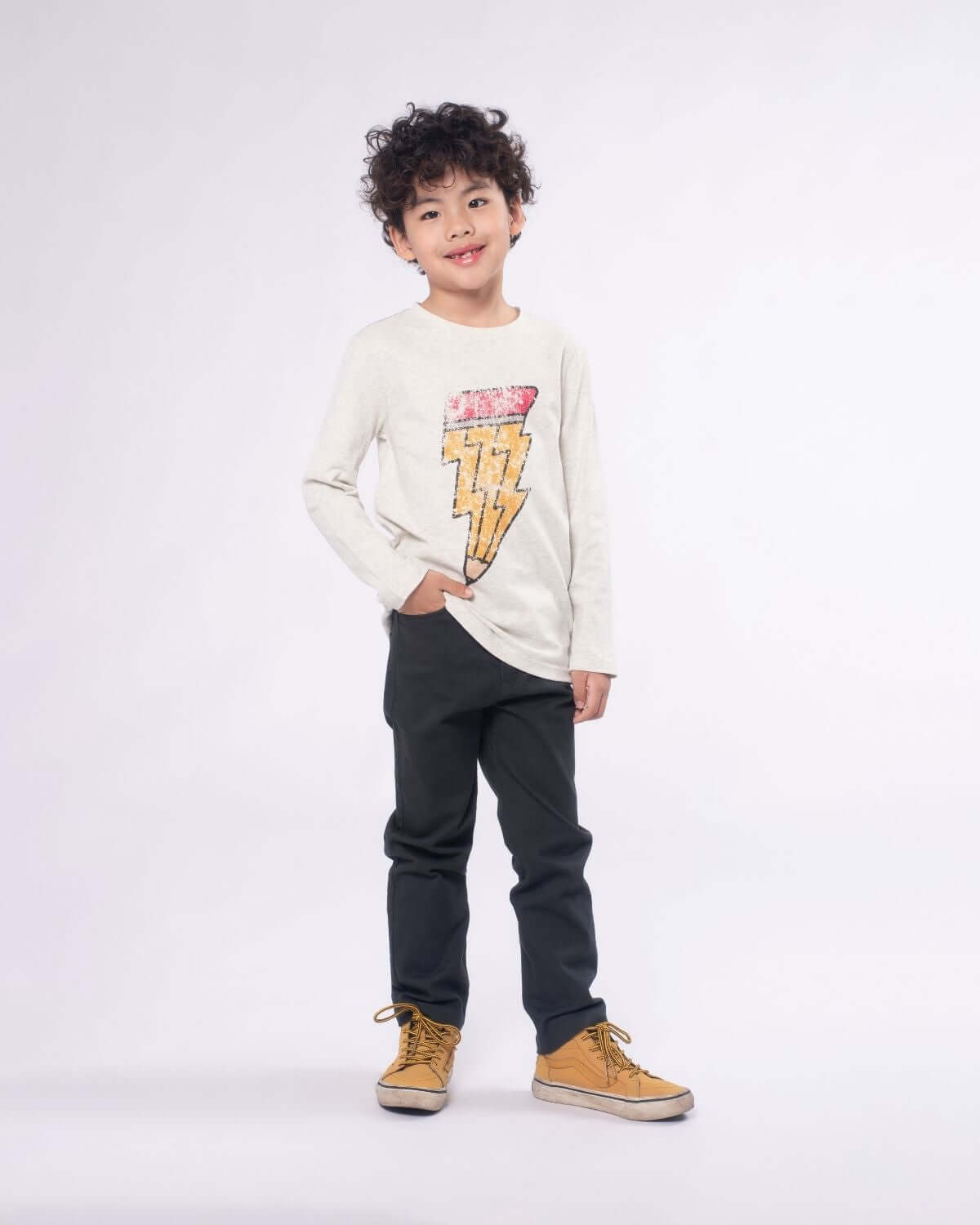 Stylish boy in Cloud Heather long sleeve tee with lightning bolt design—perfect for adventurous kids' fashion!
