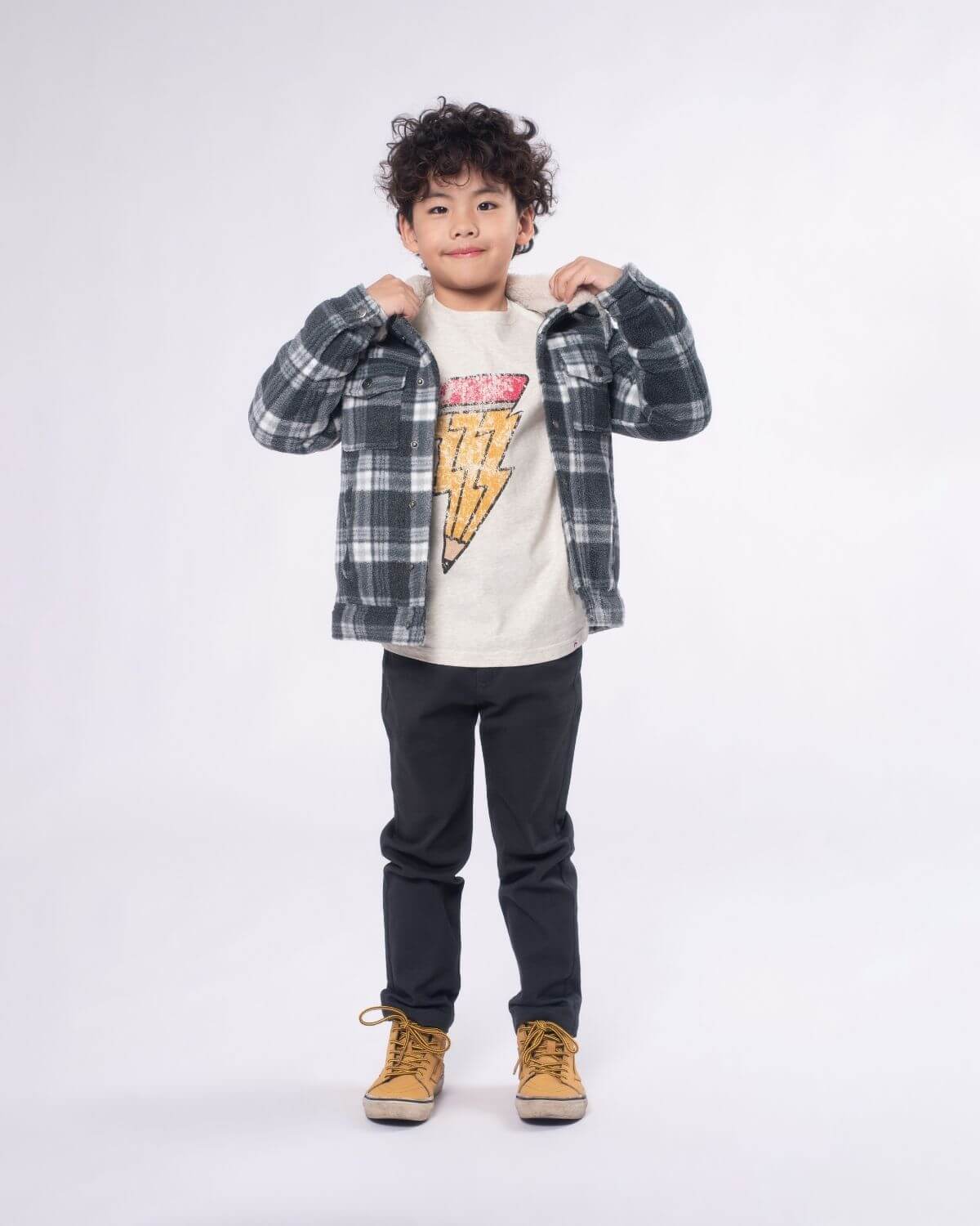 Stylish kid in a grey buffalo flannel jacket, showing off cool and cozy vibes for back to school adventures!