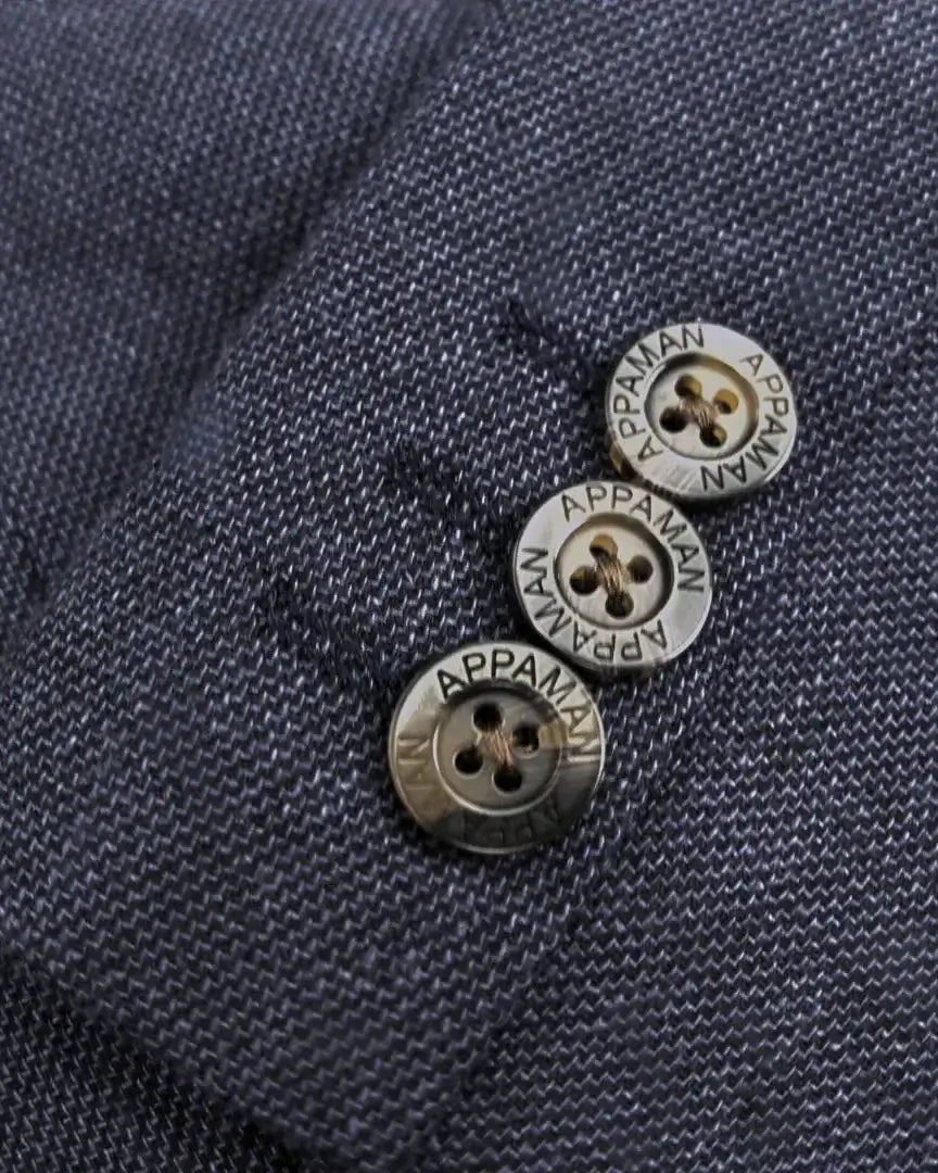 Close-up of stylish buttons on Appaman's Blue Nights Linen Trouser Shorts Suit, adding playful flair to kids' clothes.