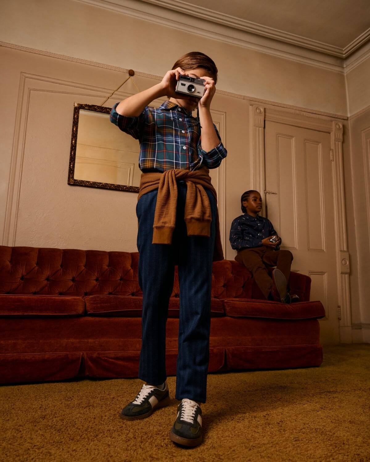 Kids in stylish Lakeside Plaid shirt capturing memories while lounging in a cozy living room—perfect back-to-school vibes!